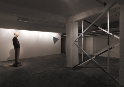 left: Ralf Sander, Goetz, 1999, maple, 185 x 50 x 72 cm; right: Noel Brennan, Samson and the Philistines (12 triangles), 2008, white deal, gaffer tape, tinting gel; photo David Monaghan